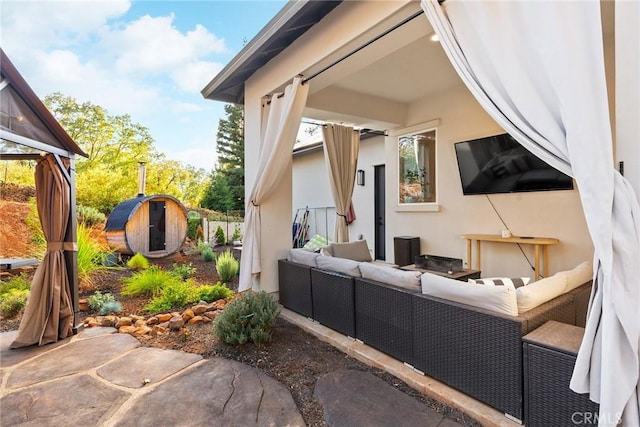 view of home's exterior with an outdoor living space and a storage shed