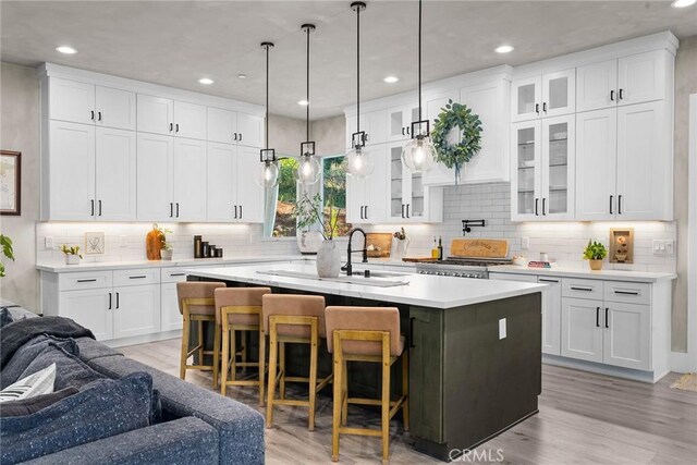5772 Acorn Ridge Dr, Paradise, CA 95969 - kitchen with a center island with sink, recessed lighting, white cabinets, tasteful backsplash, and light countertops