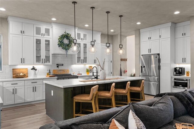 5772 Acorn Ridge Dr, Paradise, CA 95969 - kitchen with stainless steel appliances, a breakfast bar area, recessed lighting, open floor plan, and light countertops
