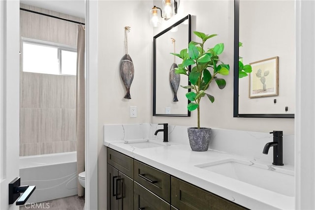 full bathroom with hardwood / wood-style flooring, shower / bath combo with shower curtain, vanity, and toilet