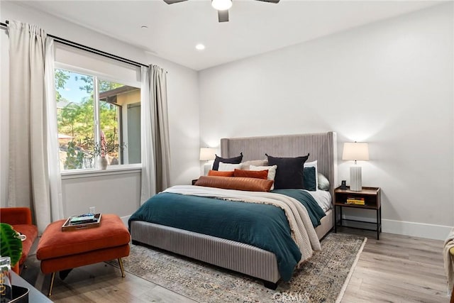 bedroom featuring ceiling fan and light hardwood / wood-style floors