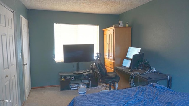 carpeted bedroom featuring a textured ceiling