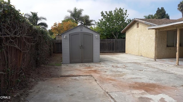 view of patio with a storage unit