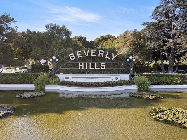 community / neighborhood sign featuring a water view