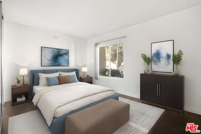 bedroom with dark hardwood / wood-style flooring