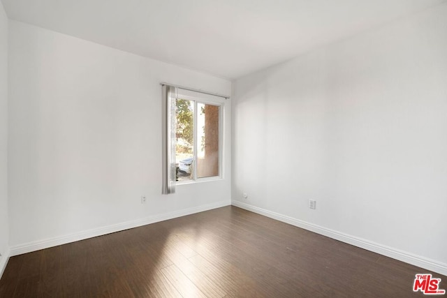 spare room featuring dark hardwood / wood-style floors