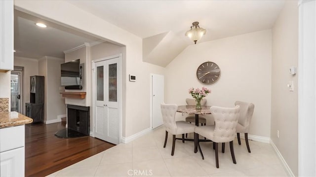 dining space with crown molding and light wood-type flooring