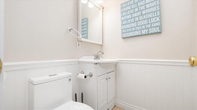 bathroom featuring vanity and toilet