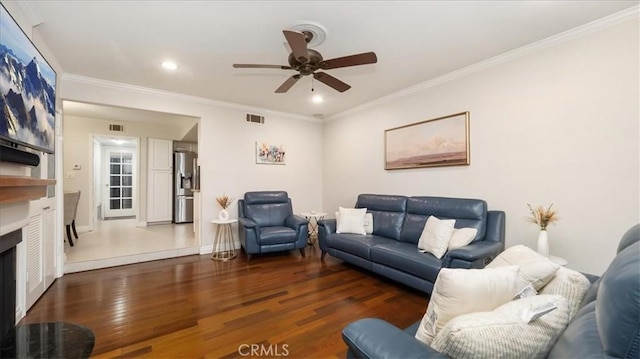 living room with ceiling fan, crown molding, and dark wood-type flooring