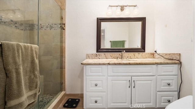 bathroom featuring vanity and a shower with shower door