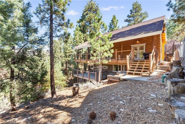 exterior space with a patio area, a deck, and french doors