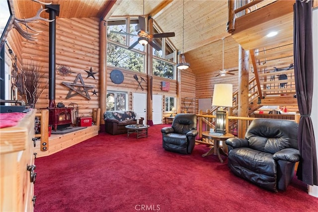 carpeted living room with beam ceiling, high vaulted ceiling, a wood stove, and ceiling fan