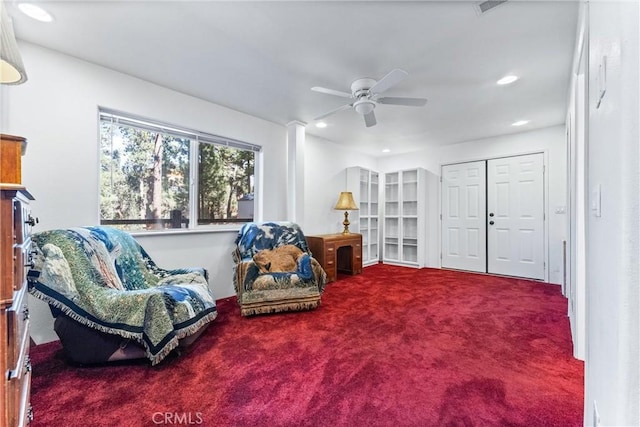 living area featuring ceiling fan and carpet floors