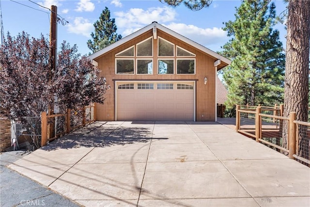 view of front of house featuring a garage and an outbuilding