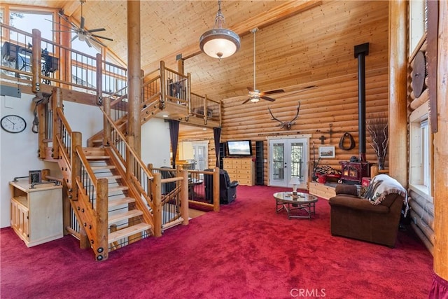 living room with high vaulted ceiling, a wood stove, carpet, wood ceiling, and french doors