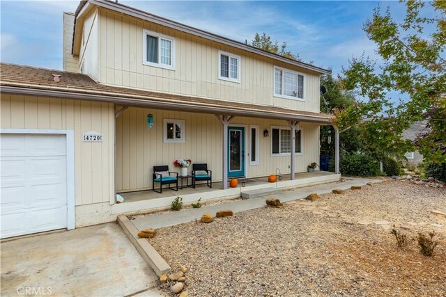 view of front of house featuring a porch and a garage