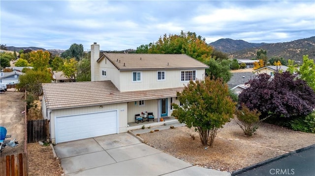 view of front of home with a mountain view and a garage