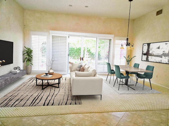 tiled living room featuring an inviting chandelier