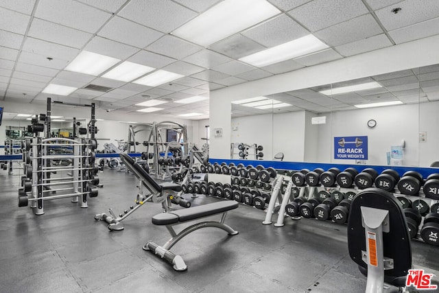 workout area with a paneled ceiling