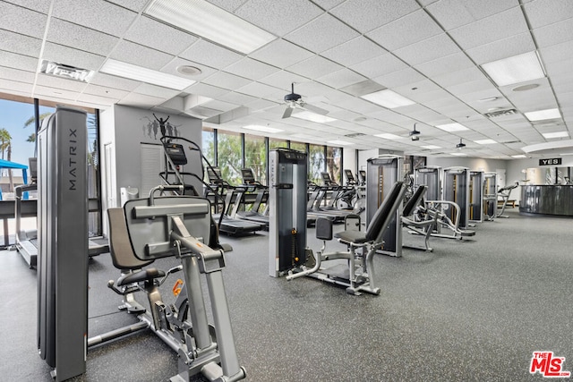 gym with ceiling fan and a drop ceiling