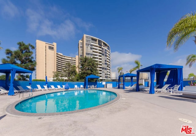 view of swimming pool with a gazebo and a patio