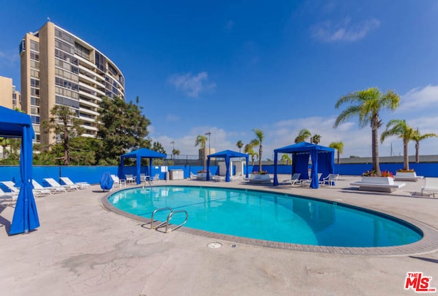 view of swimming pool featuring a gazebo and a patio