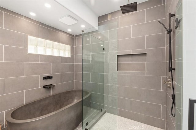 bathroom with a walk in shower and recessed lighting