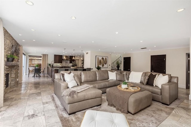 living room with marble finish floor, a fireplace, and recessed lighting