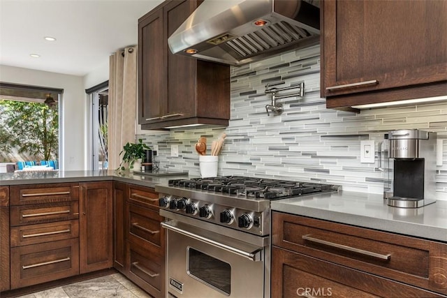 kitchen with stainless steel range, decorative backsplash, extractor fan, dark brown cabinets, and recessed lighting