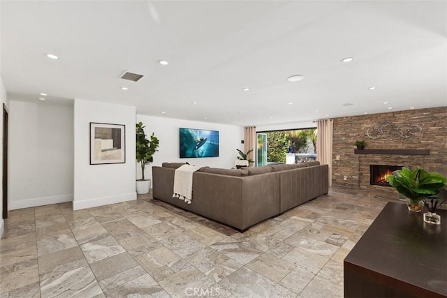 living area with recessed lighting, a fireplace, and baseboards