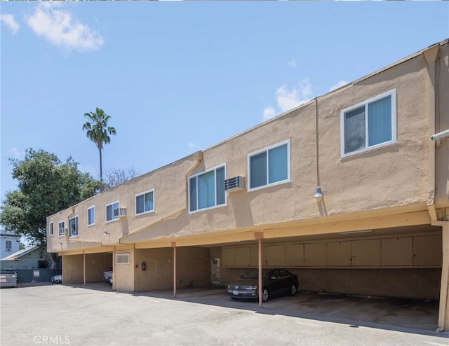 back of house featuring a carport