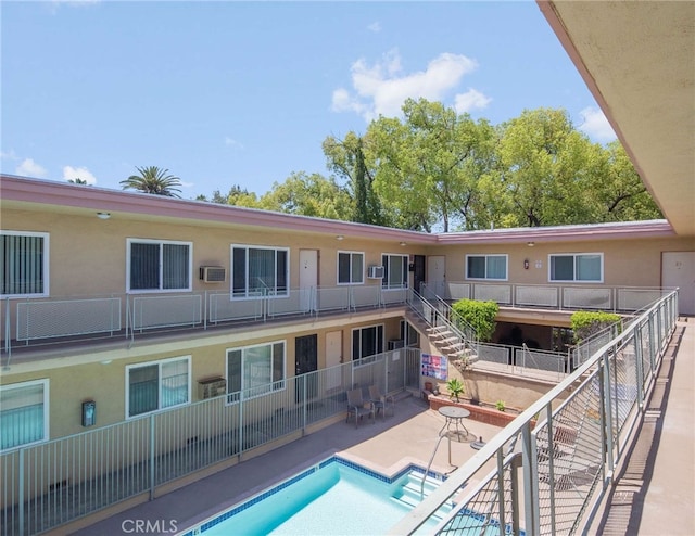 view of pool with a patio and a wall mounted AC