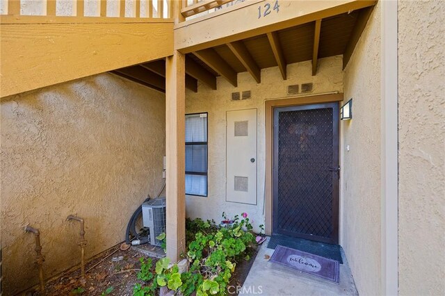 doorway to property featuring central air condition unit