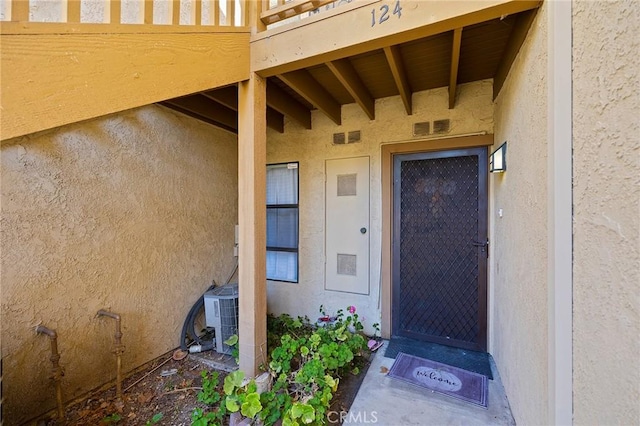 entrance to property featuring central AC unit and a balcony