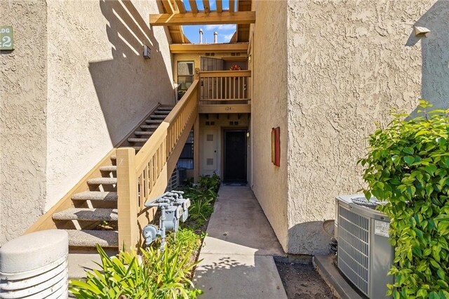 property entrance featuring central AC unit