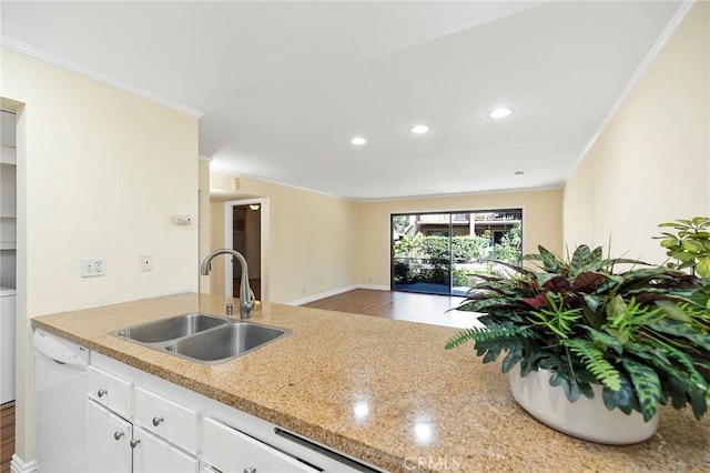 kitchen with white dishwasher, sink, white cabinetry, and crown molding