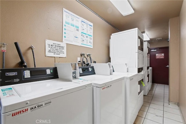 laundry area with stacked washer / dryer, independent washer and dryer, and light tile patterned flooring