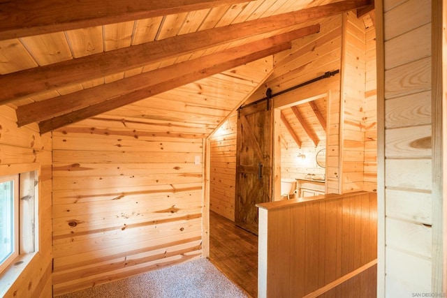 bonus room featuring lofted ceiling with beams, wood-type flooring, wood ceiling, a barn door, and wood walls