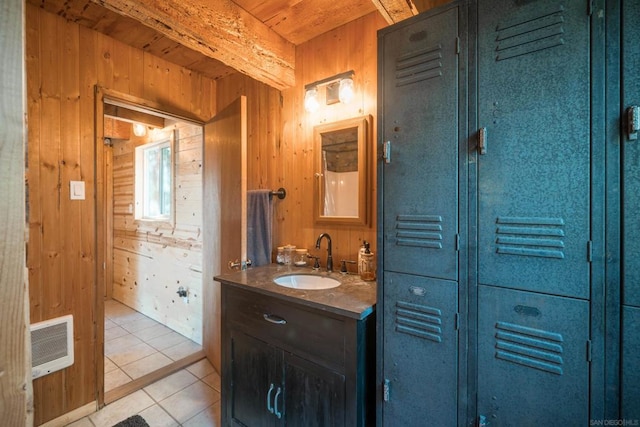 bathroom featuring vanity, wooden walls, wooden ceiling, and tile patterned floors