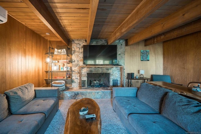 living room with beam ceiling, a stone fireplace, and wooden ceiling