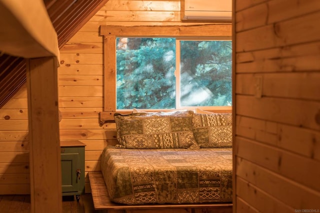 bedroom with wood-type flooring and wood walls