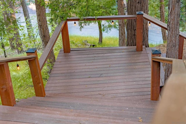 wooden terrace featuring a water view