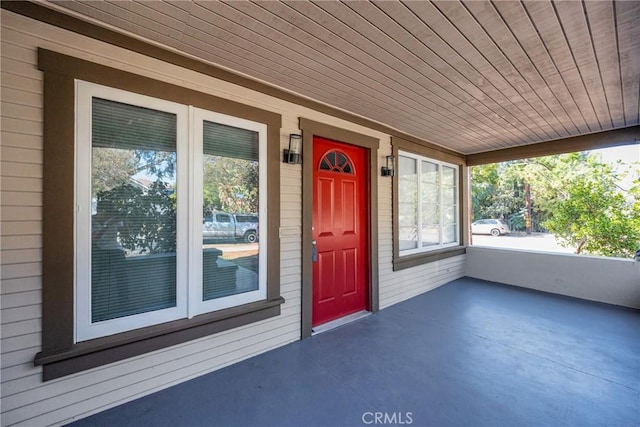 view of exterior entry with a porch