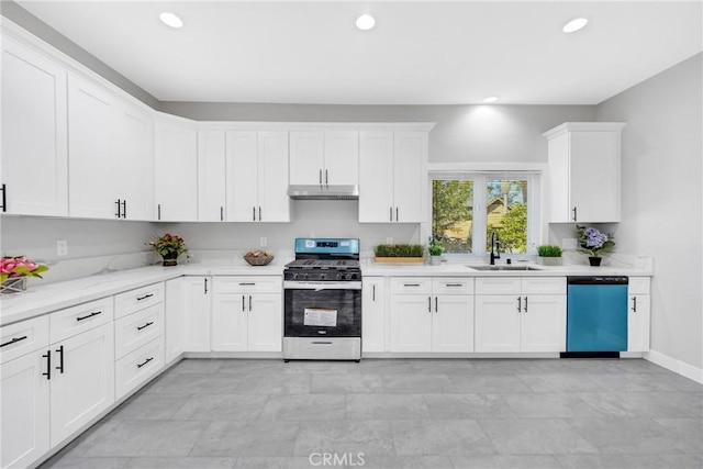 kitchen with light stone counters, sink, white cabinets, and stainless steel appliances