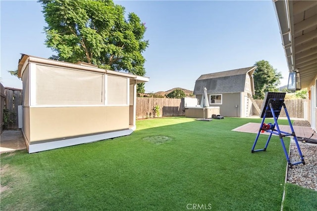 view of yard featuring a hot tub and a storage shed