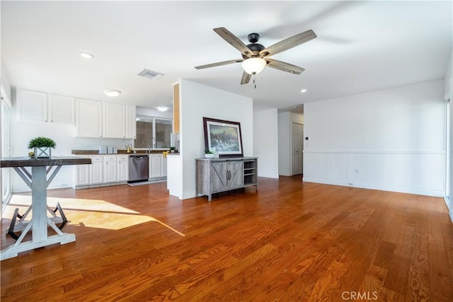 unfurnished living room featuring visible vents, wood finished floors, recessed lighting, wainscoting, and ceiling fan