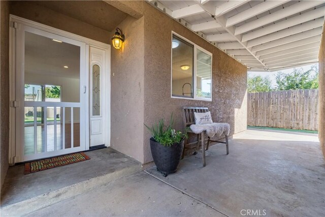 view of exterior entry with covered porch