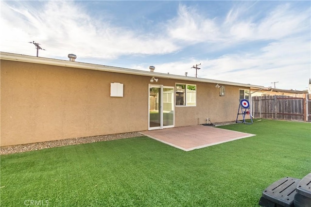 rear view of house with a patio area and a yard