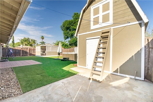 view of yard featuring an outbuilding, a patio, and central AC unit