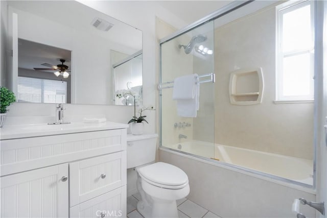 full bathroom with ceiling fan, tile patterned floors, toilet, shower / bath combination with glass door, and vanity